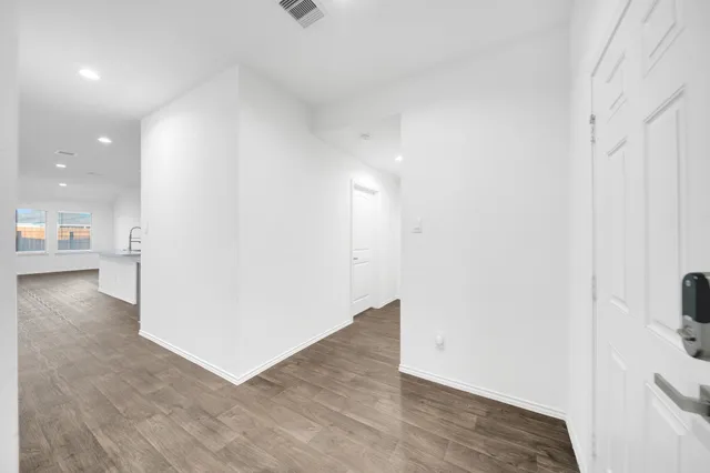 an empty room with a window and a ceiling fan