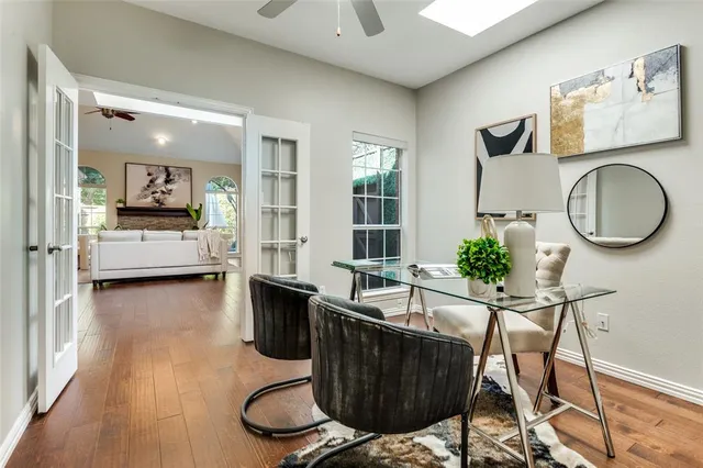 a living room with furniture a flat screen tv and a large window