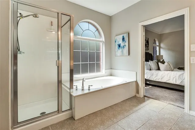 a bathroom with bathtub and a shower