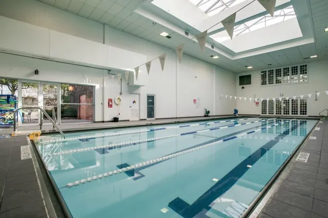 a view of a kitchen with kitchen island a large window appliances and cabinets