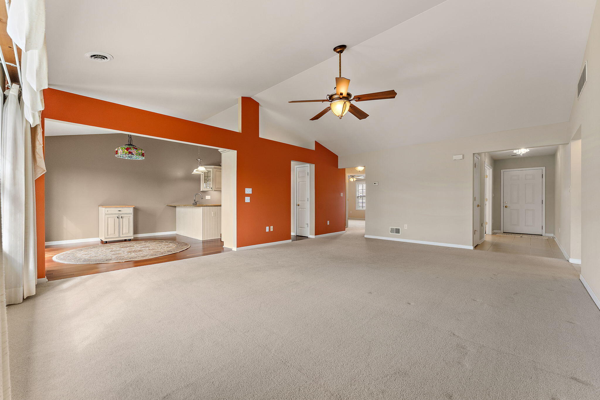 901 Veterans Lane Crown Point, IN 46307 - Photo 8 of 40 a view of a big room with a ceiling fan and kitchen view