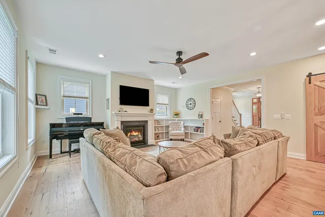 a living room with furniture and kitchen view
