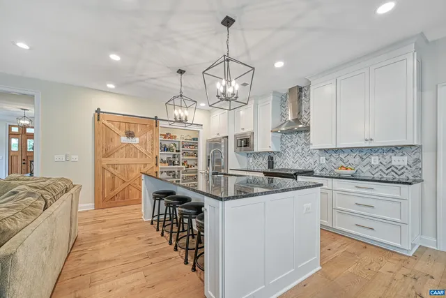 a kitchen with stainless steel appliances granite countertop a sink and stove