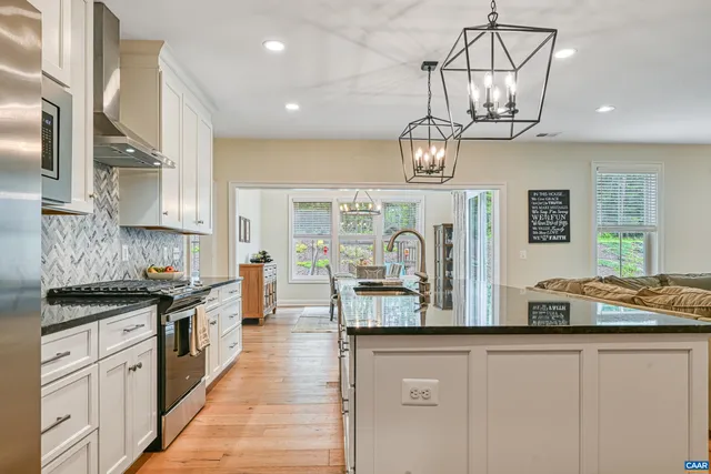 a kitchen with stainless steel appliances granite countertop a sink and stove