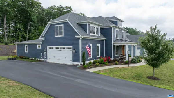 a view of a livingroom with wooden floor and furniture