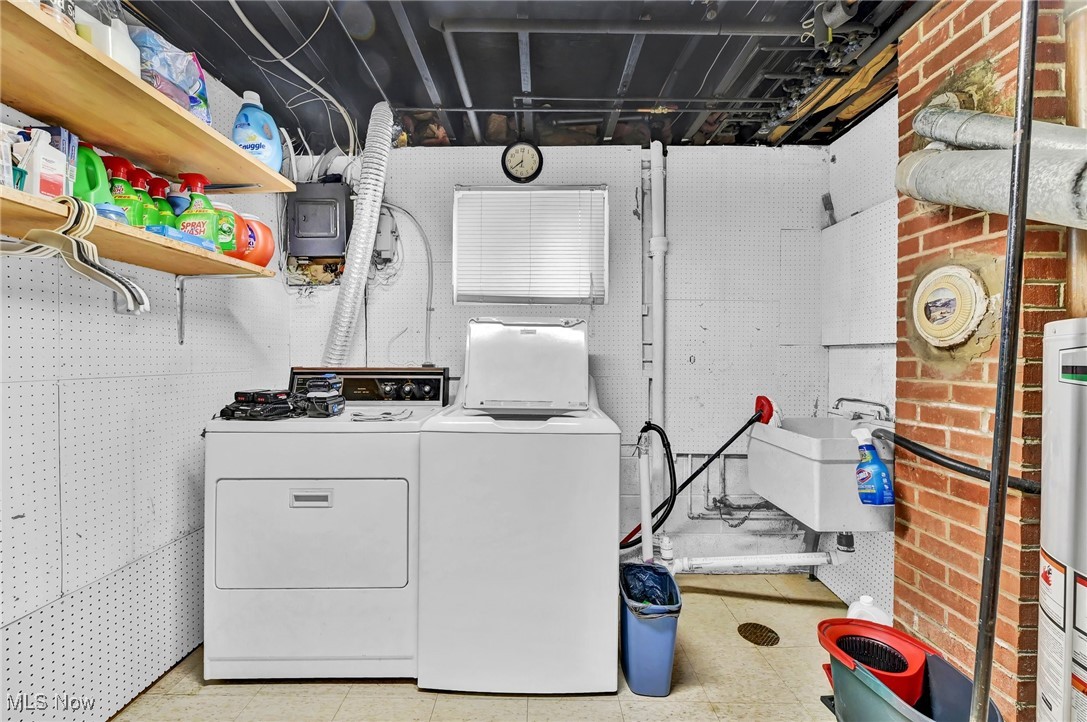 7676 Brecksville Road Independence, OH 44131 - Photo 22 of 32 Laundry area with a sink, separate washer and dryer, laundry area, and gas water heater