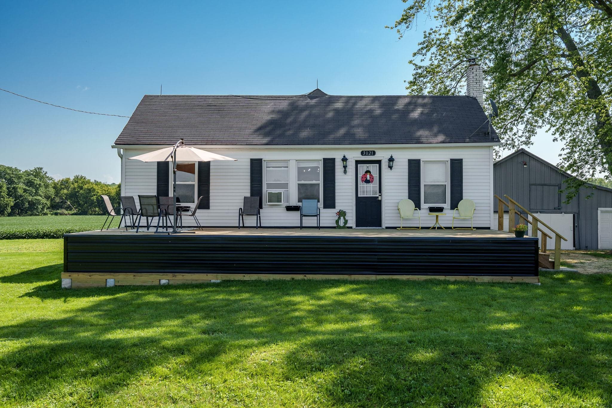 a front view of a house with a yard table and chairs