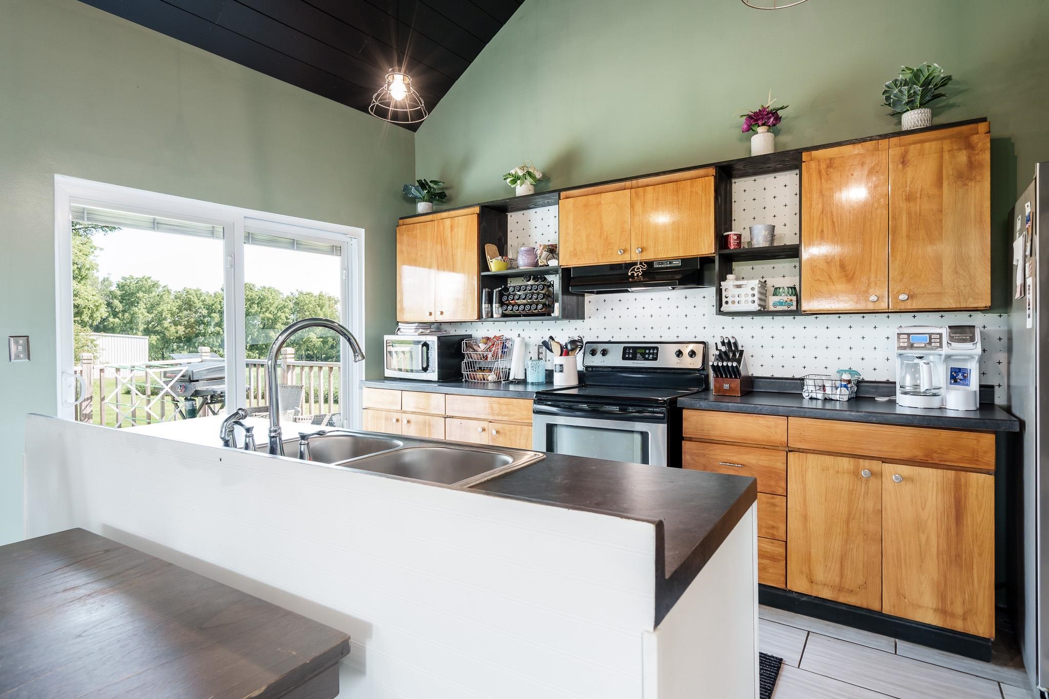 3021 North Dakota Road Freeport, IL 61032 - Photo 17 of 44 a kitchen with stainless steel appliances granite countertop a stove a sink and a microwave