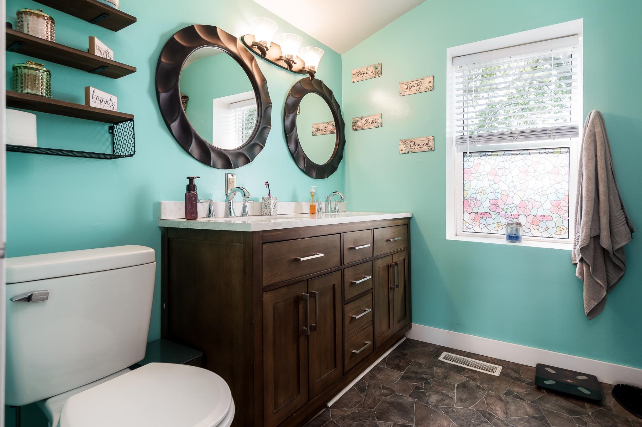 3021 North Dakota Road Freeport, IL 61032 - Photo 19 of 44 a bathroom with a toilet sink vanity and mirror