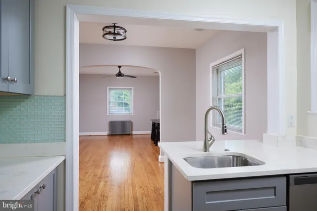 a kitchen with a sink and a mirror