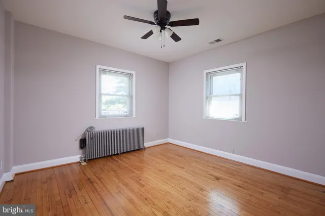 a room with window and hardwood floor