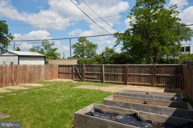 a backyard of a house with wooden floor and fence