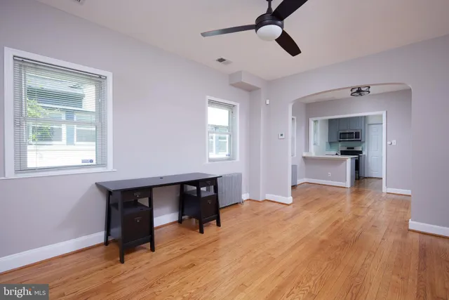 a view of work space with wooden floor and a window