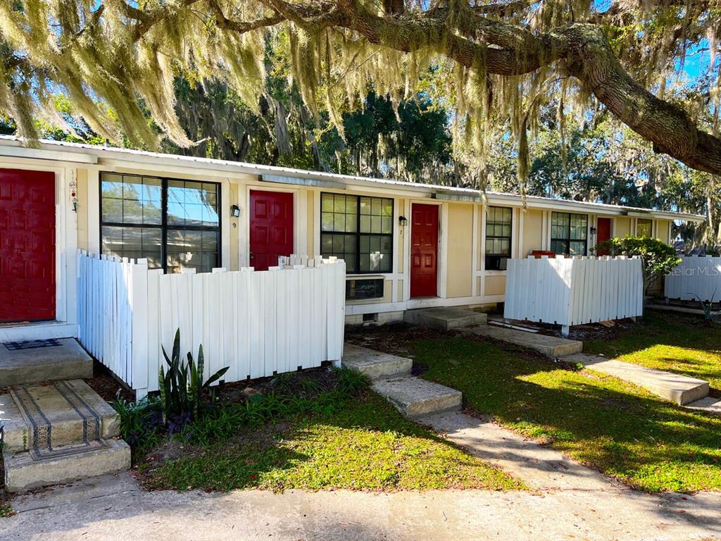 420 Mills Street, Unit 34 Leesburg, FL 34748 - Photo 1 of 1 a view of a house with backyard and sitting area
