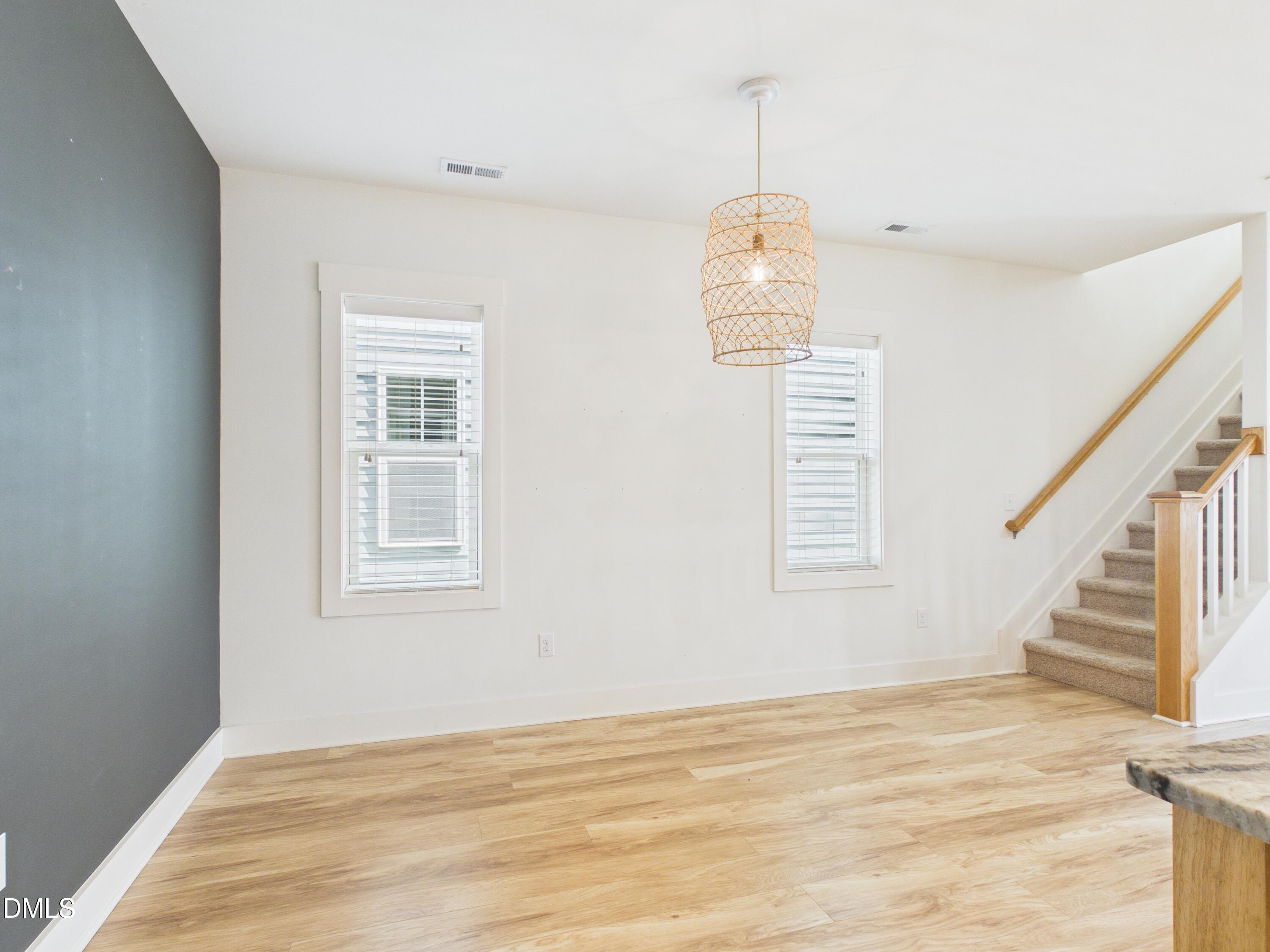 748 Groveview Wendell, NC 27591 - Photo 13 of 38 a view of an empty room with wooden floor and a window