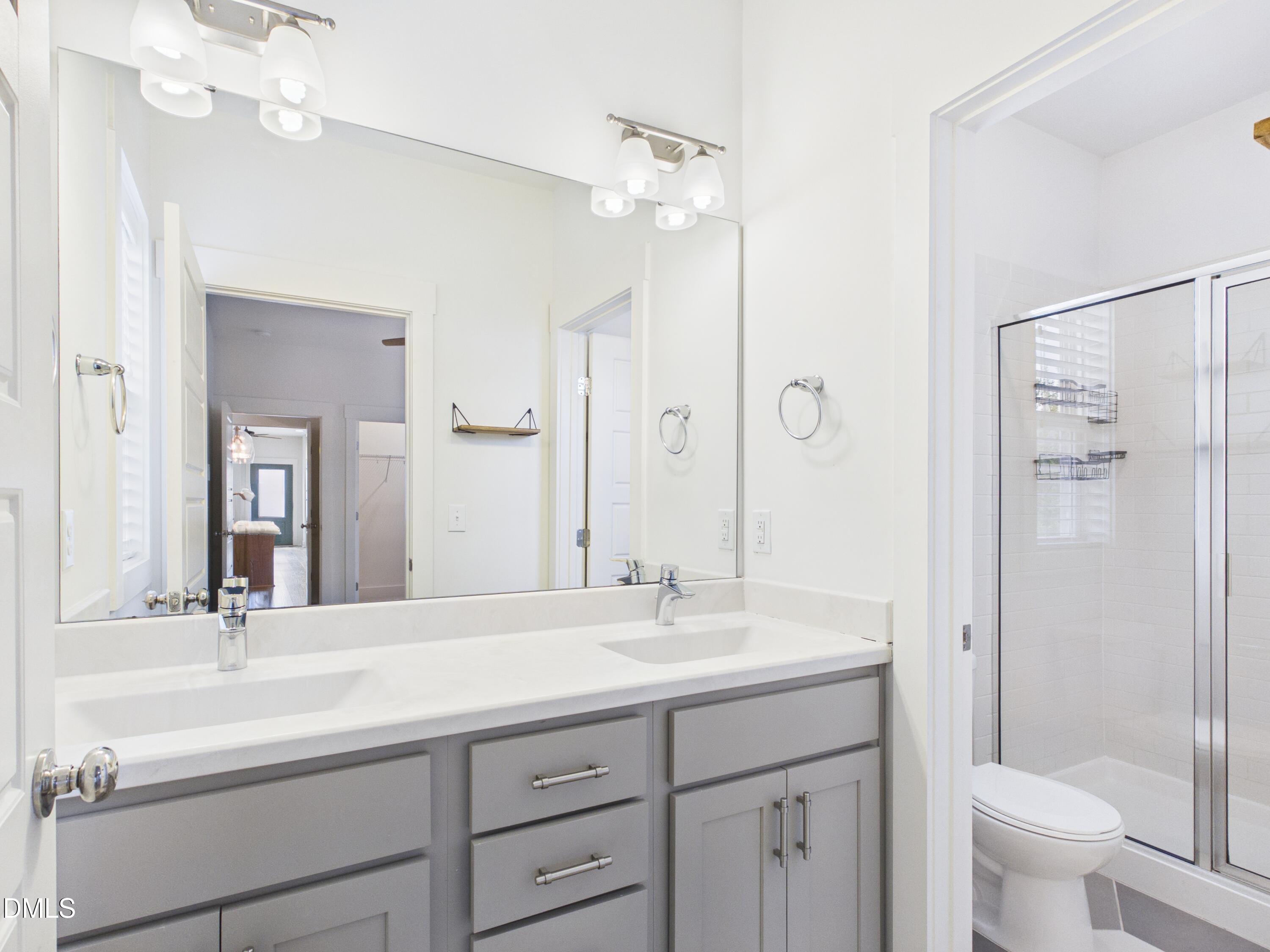 748 Groveview Wendell, NC 27591 - Photo 17 of 38 a bathroom with a double vanity sink mirror double and shower