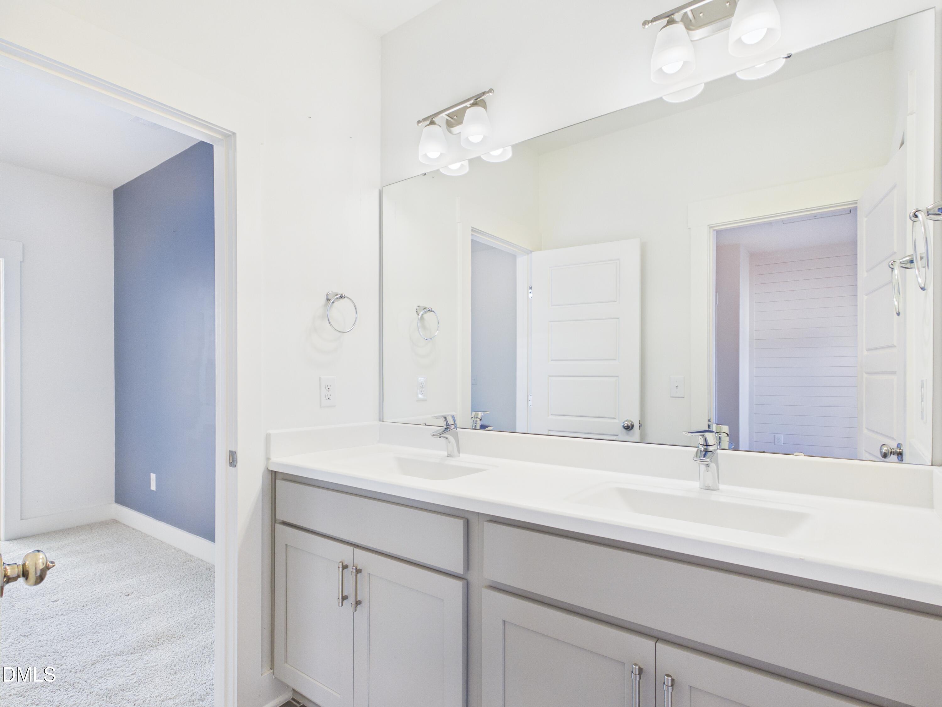 748 Groveview Wendell, NC 27591 - Photo 28 of 38 a bathroom with a sink vanity and a mirror