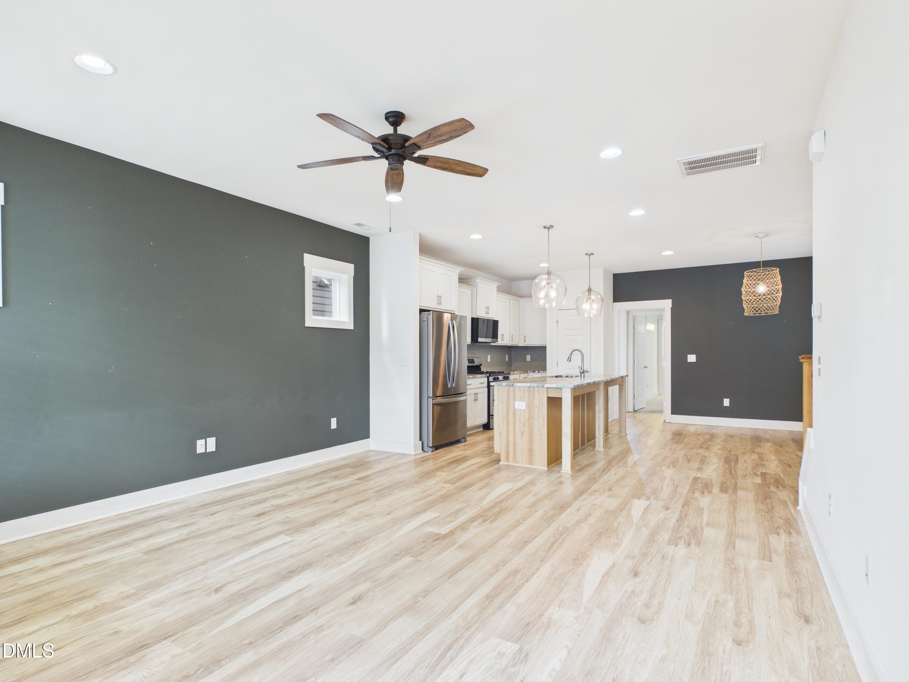748 Groveview Wendell, NC 27591 - Photo 7 of 38 a view of kitchen with stainless steel appliances kitchen island sink and refrigerator