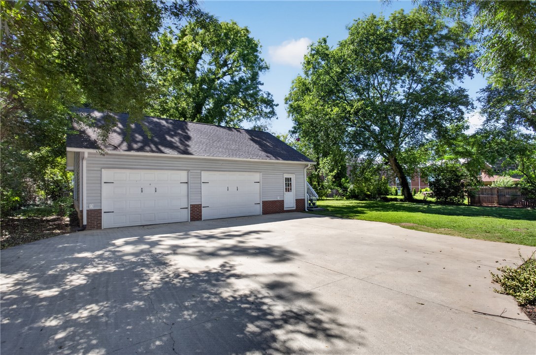 110 South Fairplay Street Seneca, SC 29678 - Photo 9 of 50 A spacious two-car detached garage offers ample storage and parking, complemented by a broad concrete driveway.