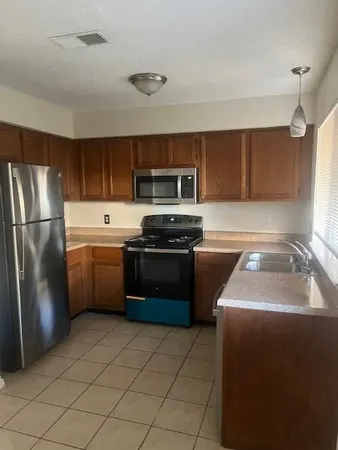 a kitchen with a sink a stove and refrigerator
