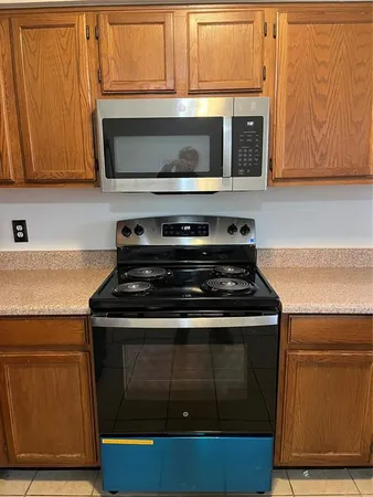 a stove top oven sitting inside of a kitchen