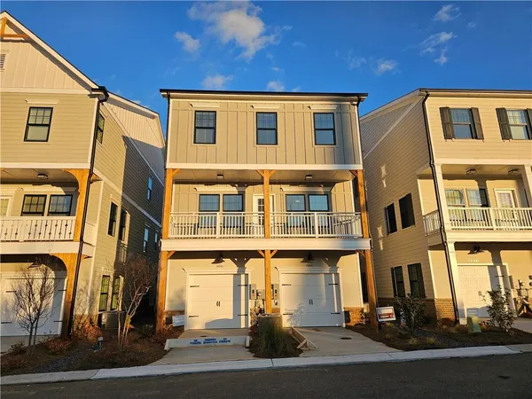 a front view of a residential apartment building with a yard