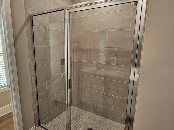 a bathroom with a glass door shower