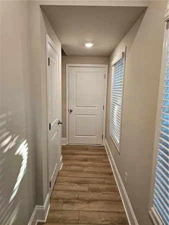 a view of a hallway with wooden floor and staircase