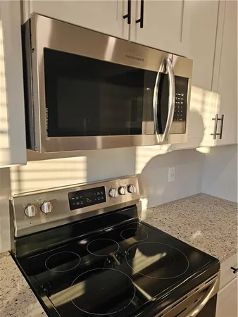 a stove top oven sitting inside of a kitchen