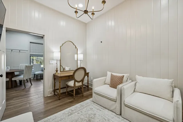 a view of a swimming pool with a patio and glass windows
