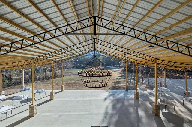 a backyard of a house with table and chairs