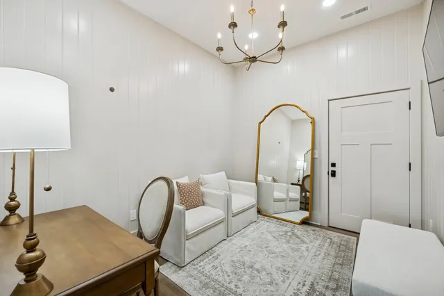 a large dining hall with stainless steel appliances granite countertop a stove oven and a dining table with wooden floors