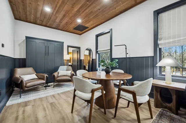 a view of a dining room with furniture wooden floor and chandelier