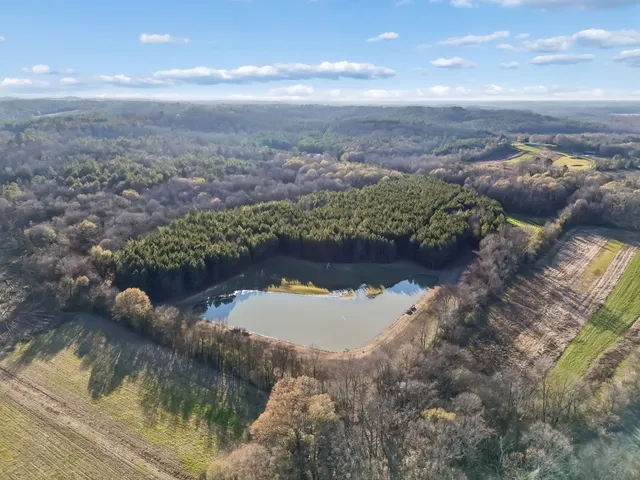 a view of a hallway with wooden floor and workspace