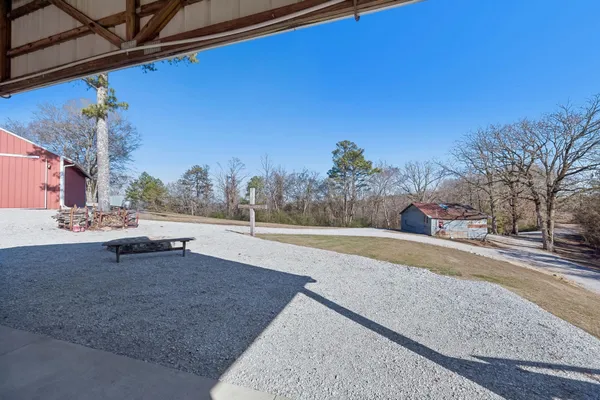 a backyard of a house with table and chairs