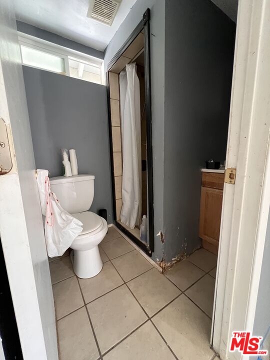 8903 Ramsgate Avenue Los Angeles, CA 90045 - Photo 14 of 15 a white toilet sitting next to a bathroom sink