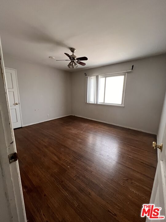 8903 Ramsgate Avenue Los Angeles, CA 90045 - Photo 4 of 15 an empty room with wooden floor and windows