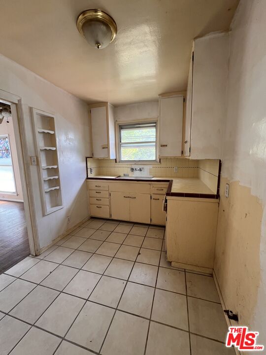 8903 Ramsgate Avenue Los Angeles, CA 90045 - Photo 6 of 15 a kitchen with stainless steel appliances a stove a sink and a refrigerator