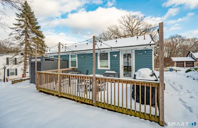 a view of a house with a wooden deck