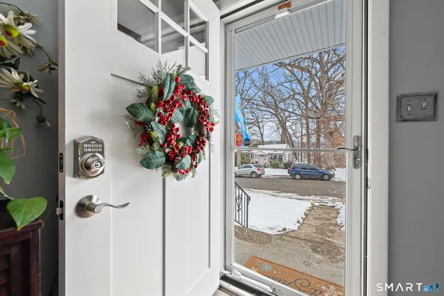 a vase of flowers sitting on a table in front of a door