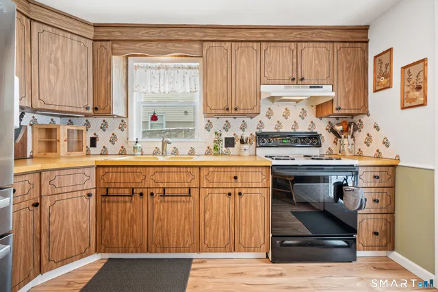 a kitchen with a sink cabinets and window