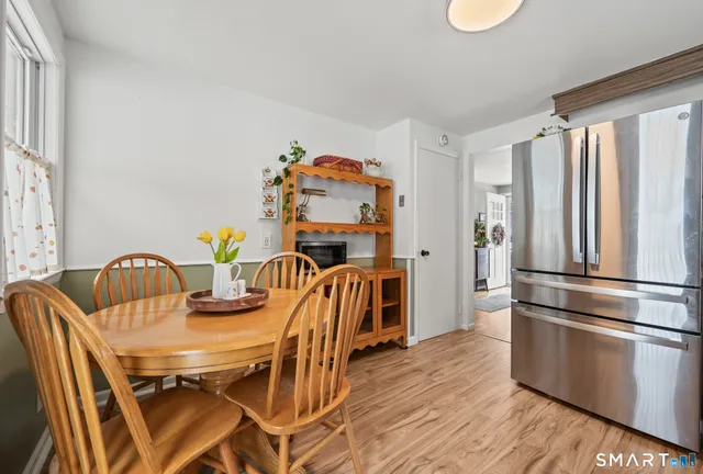 a dining room with furniture and wooden floor