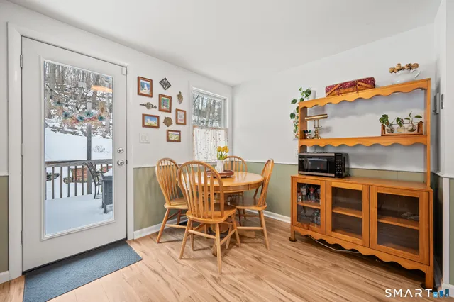 a view of a dining room with furniture wooden floor and a window