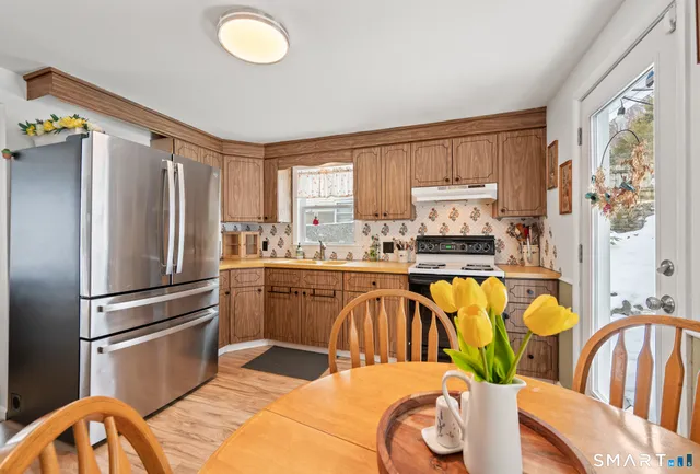 a kitchen with stainless steel appliances granite countertop a refrigerator and a stove top oven