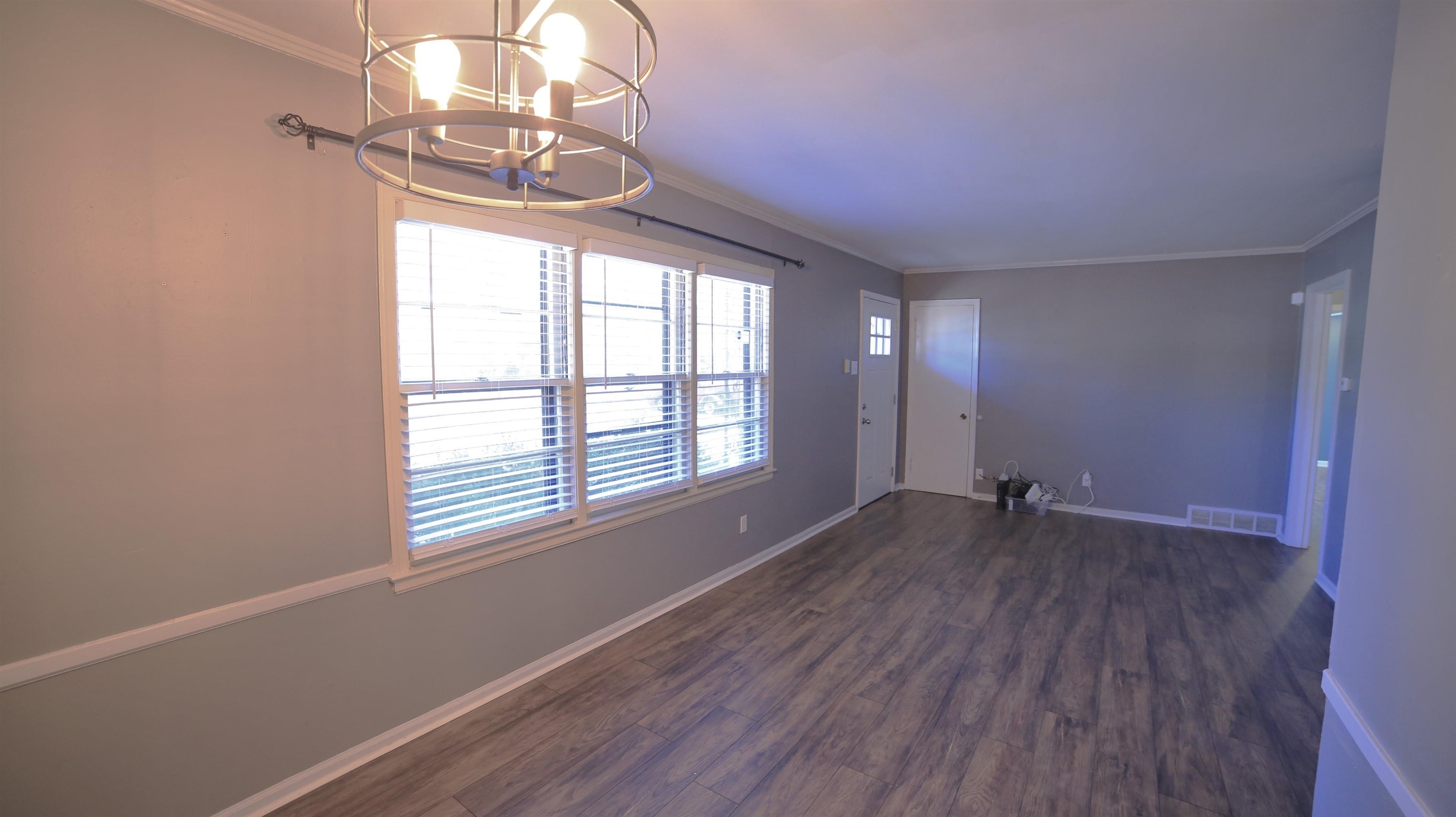 1605 Marcia Road Memphis, TN 38117 - Photo 2 of 15 an empty room with wooden floor and windows