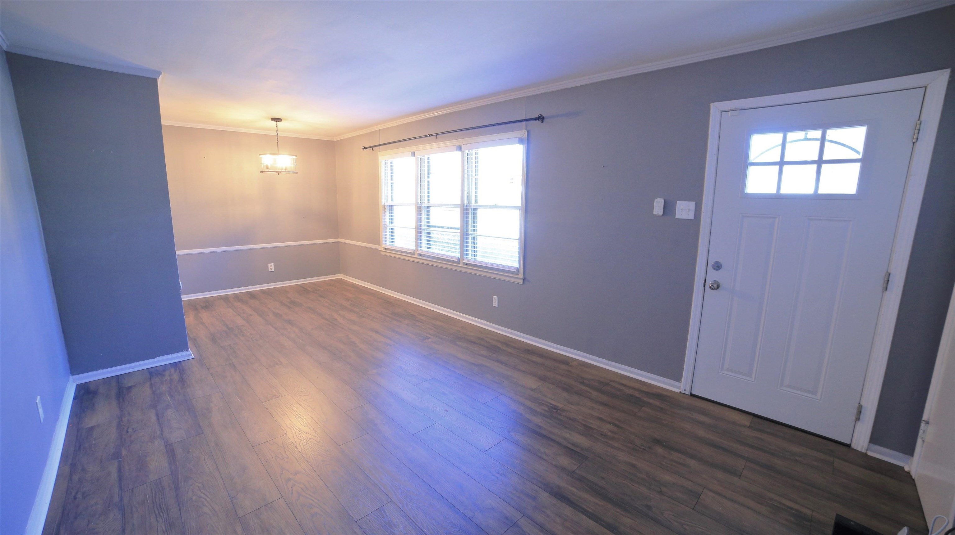 1605 Marcia Road Memphis, TN 38117 - Photo 3 of 15 an empty room with wooden floor and windows
