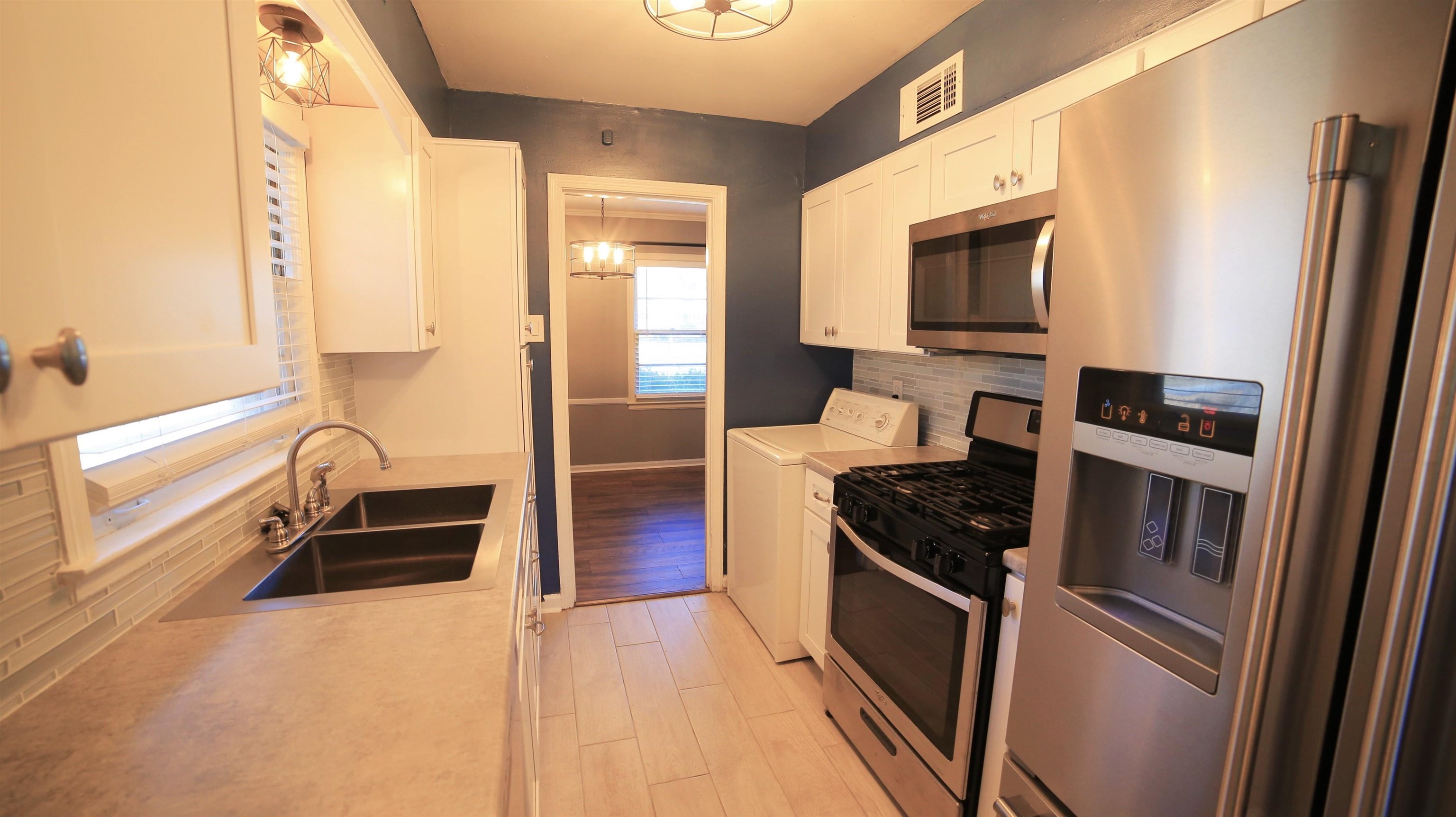 1605 Marcia Road Memphis, TN 38117 - Photo 6 of 15 a kitchen with granite countertop a refrigerator and a sink