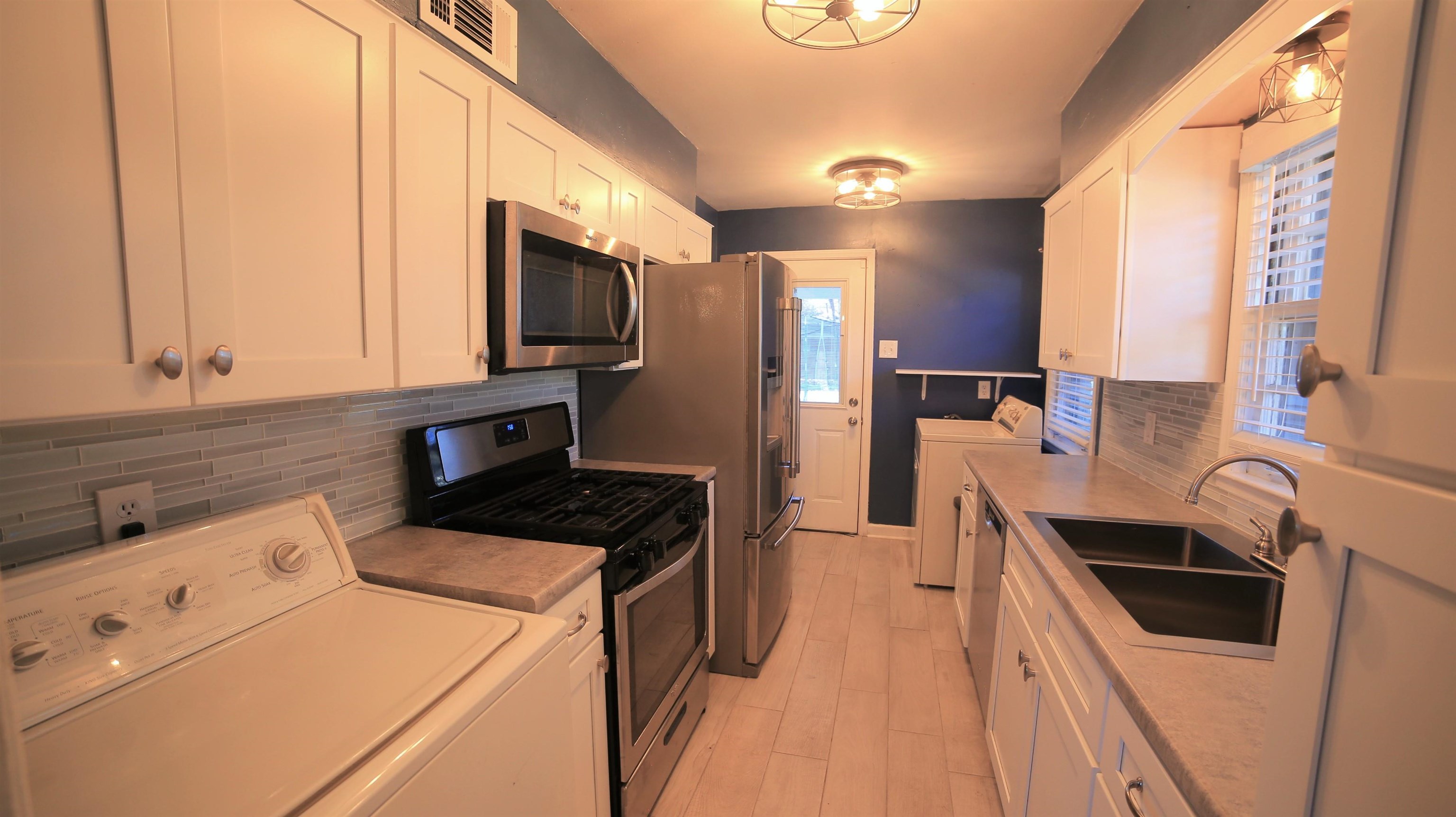 1605 Marcia Road Memphis, TN 38117 - Photo 7 of 15 a kitchen that has a sink a stove top oven and refrigerator