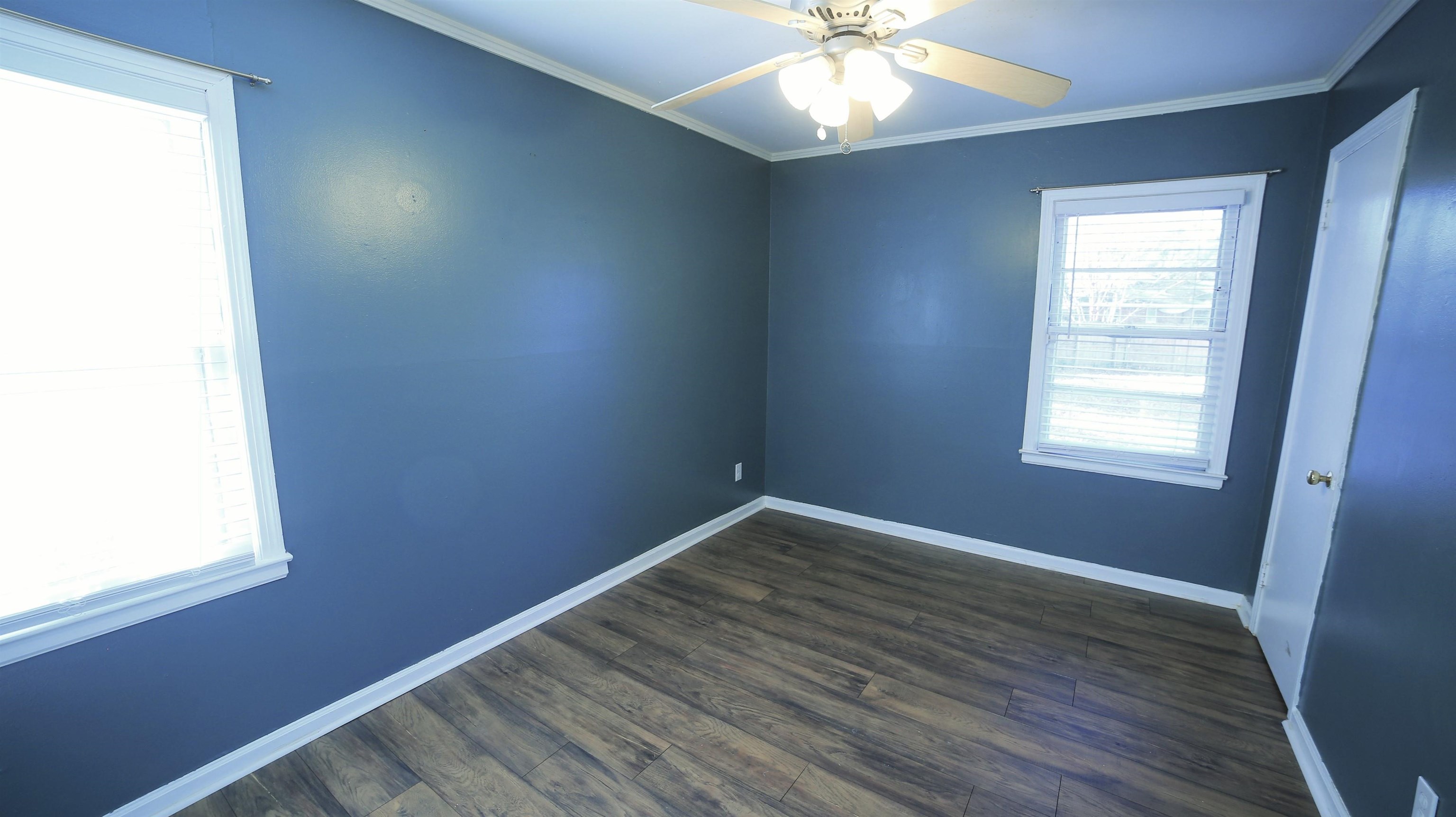 1605 Marcia Road Memphis, TN 38117 - Photo 9 of 15 an empty room with wooden floor and windows