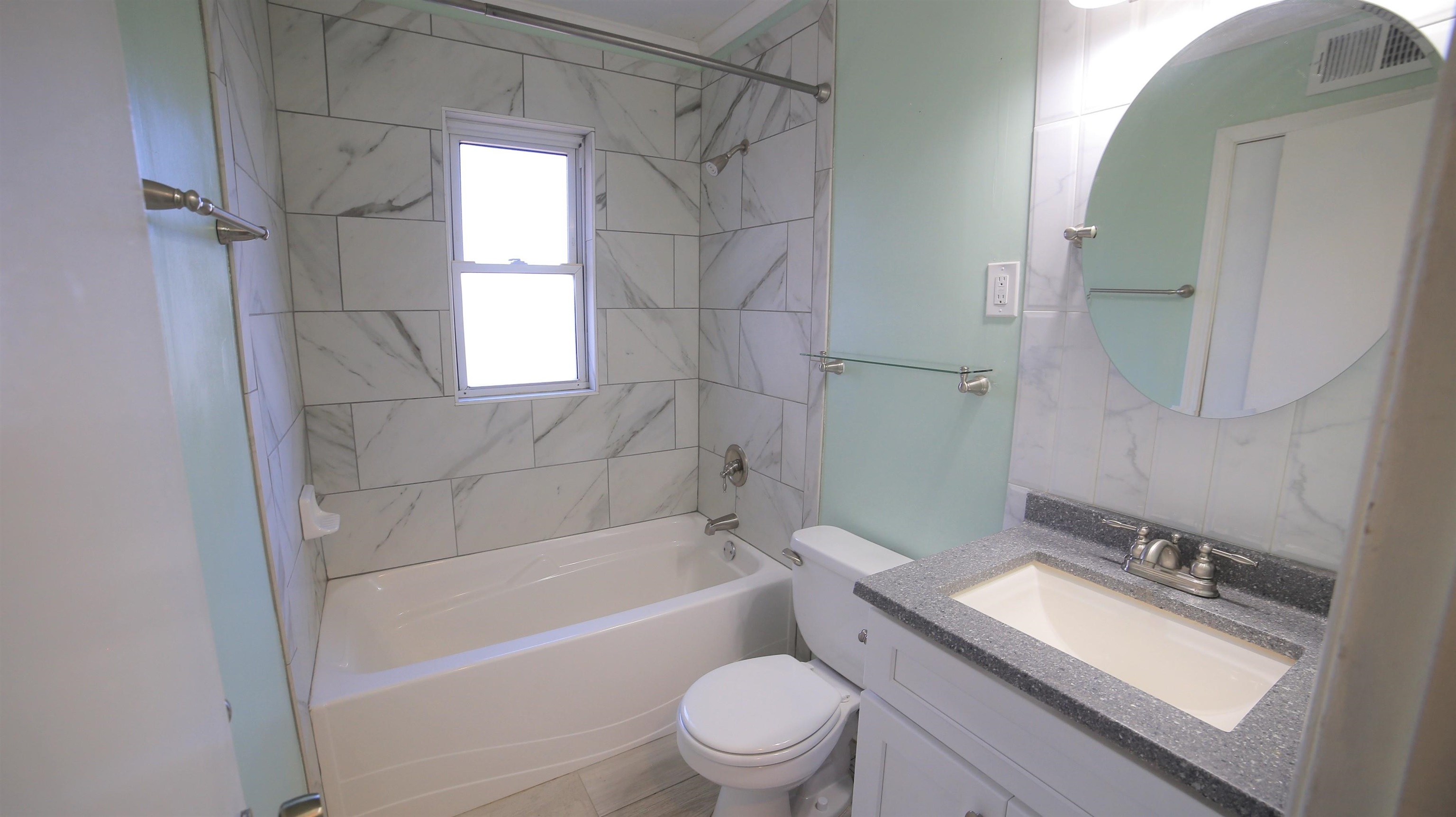 1605 Marcia Road Memphis, TN 38117 - Photo 10 of 15 a bathroom with a sink toilet vanity and shower